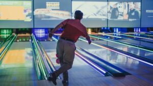 man playing bowl in bowling lane