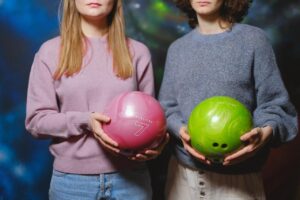 2 girls holding balls in their hand