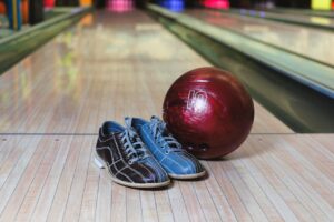 Bowling Ball and Shoes on Alley