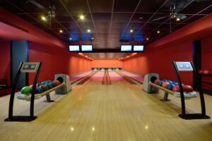 Bowling balls and wooden lanes in bowling alley