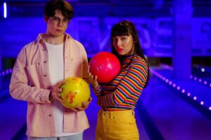 a boy and girl is holding ball