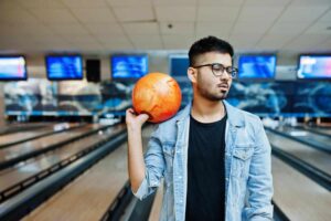 man standing at bowling alley