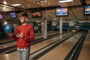 man standing bowling alley