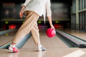 person playing bowling in the lane