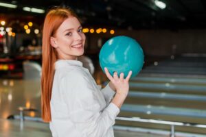 women holding a bowling ball