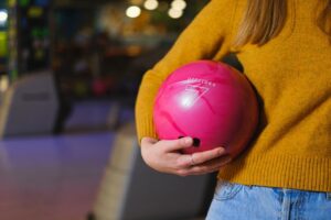 women holding a bowling ball