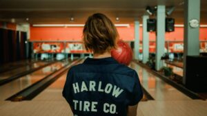 women standing in bowling alley