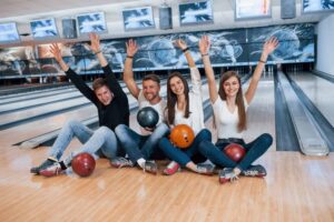 young people enjoying bowling