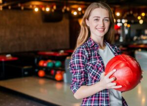 young women holding a bowling ball