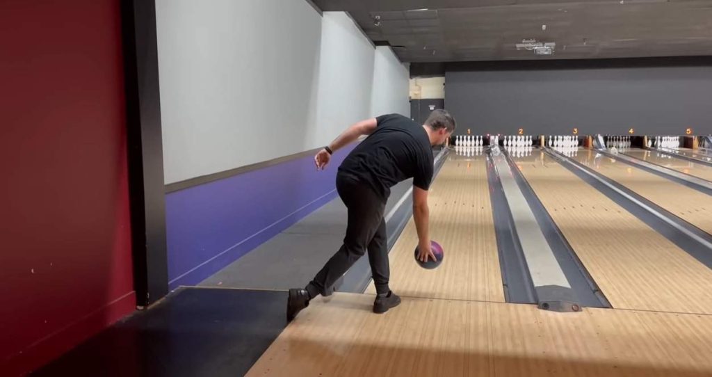 a player is taking position to release the bowling ball